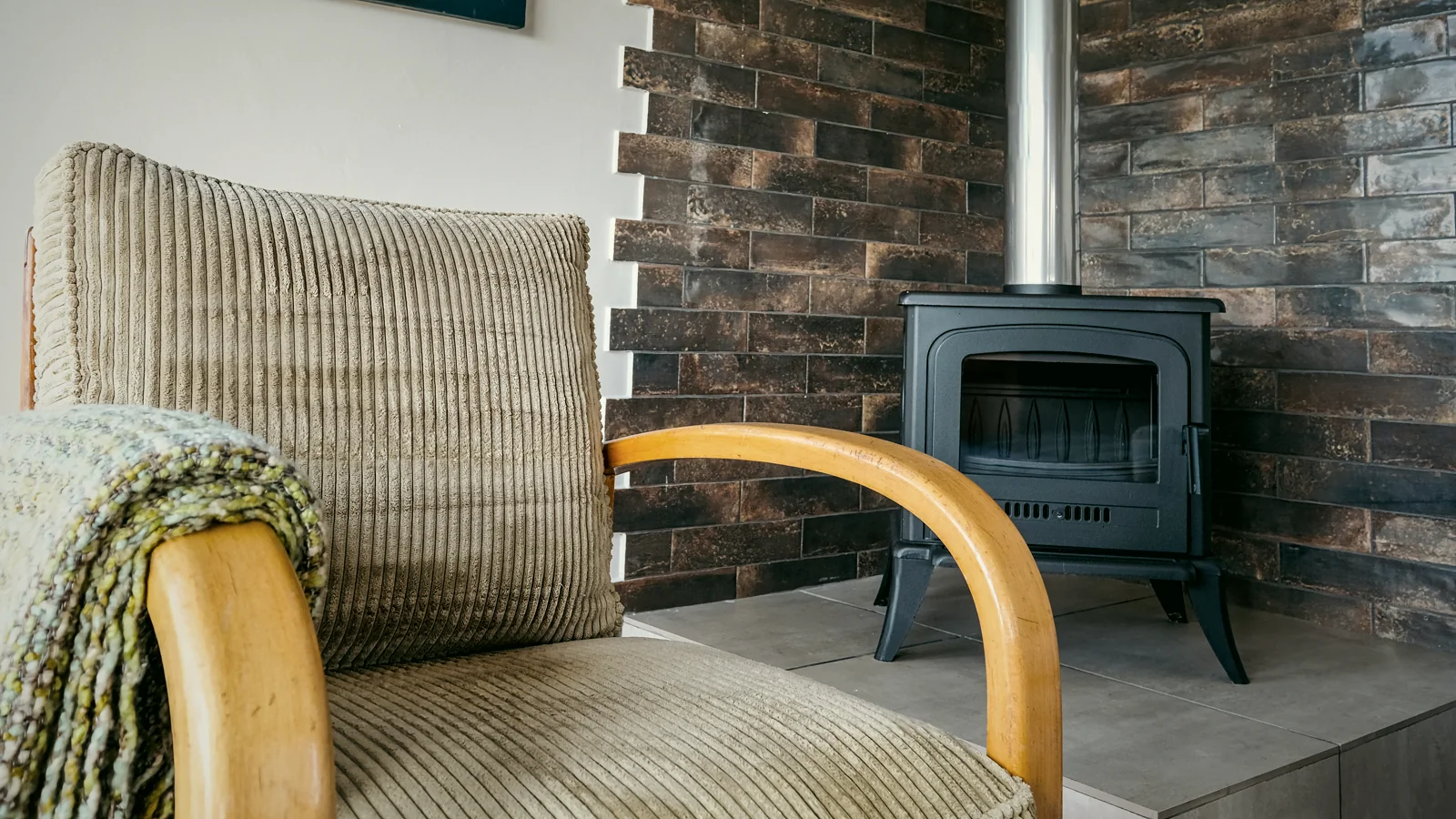 Armchair beside the wood-burning fireplace